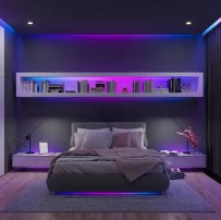 Modern bedroom with a bed, shelves, and colorful lighting